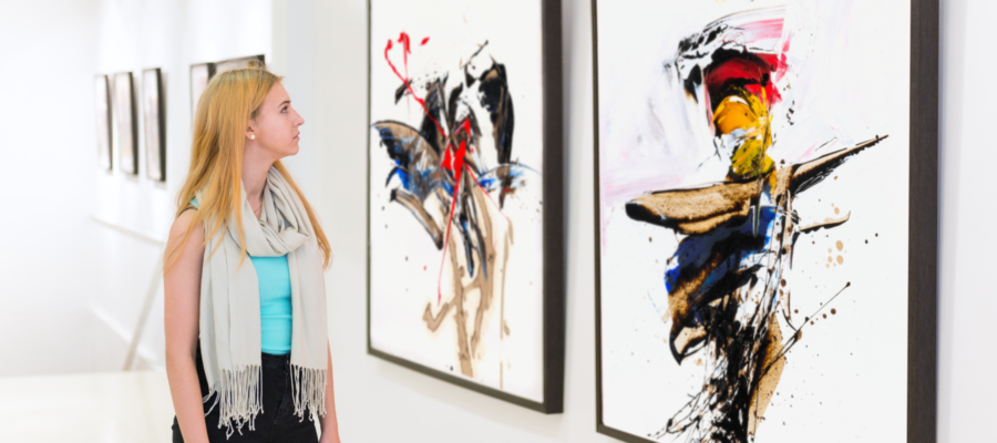 blond woman looking at abstract art in a gallery