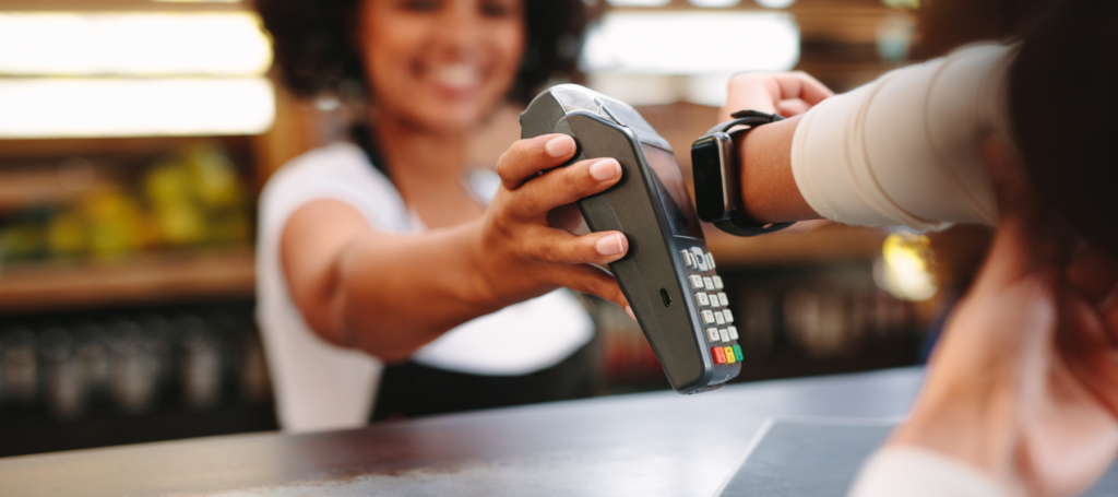 woman taking google watch wireless payment on a card reader